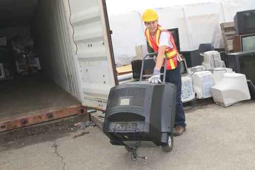 Operatives assessing risk and securing bins at a business site